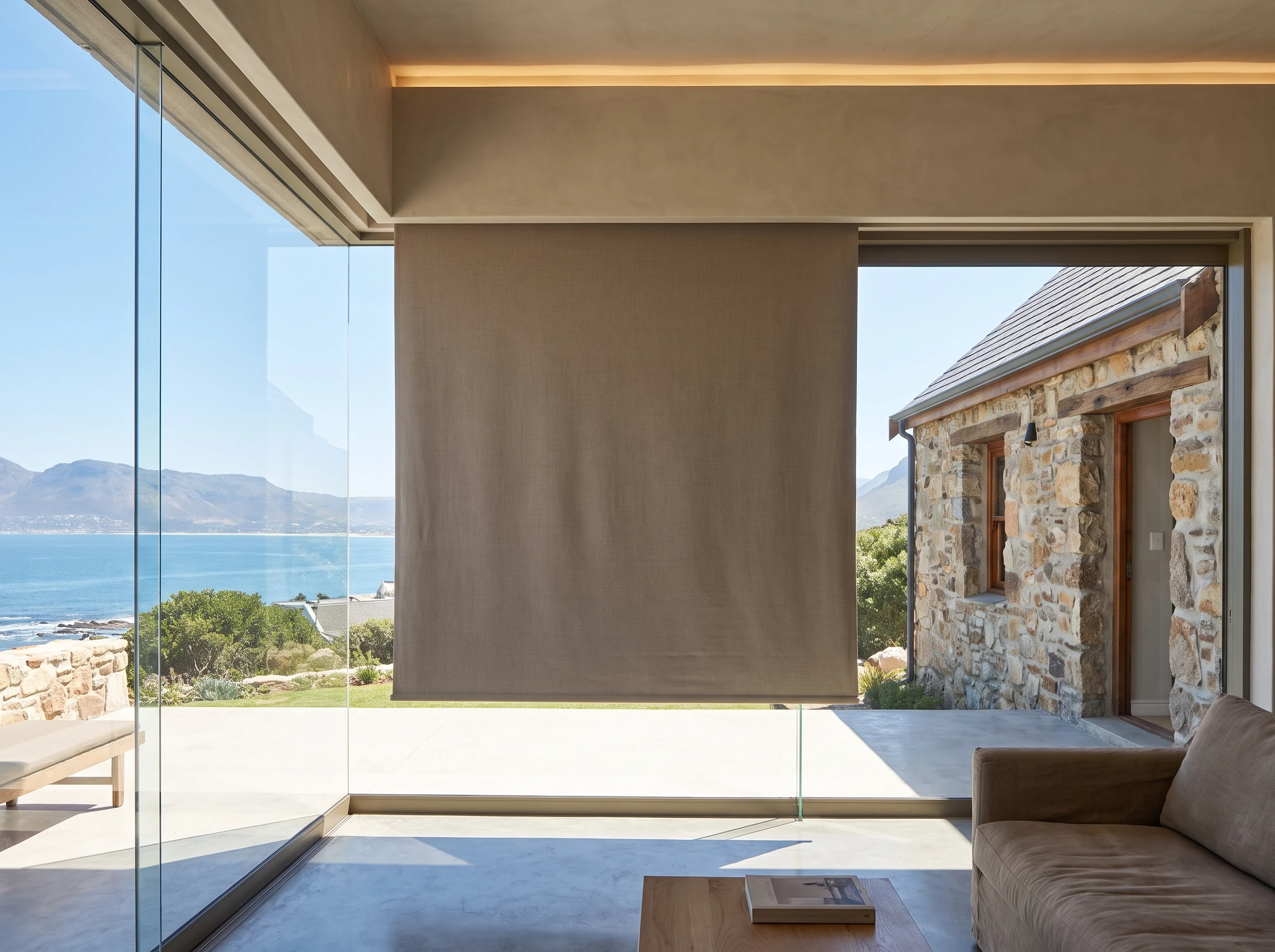 Roller blind concealed in a slim ceiling recess above frameless glass in a renovated St James cottage extension
