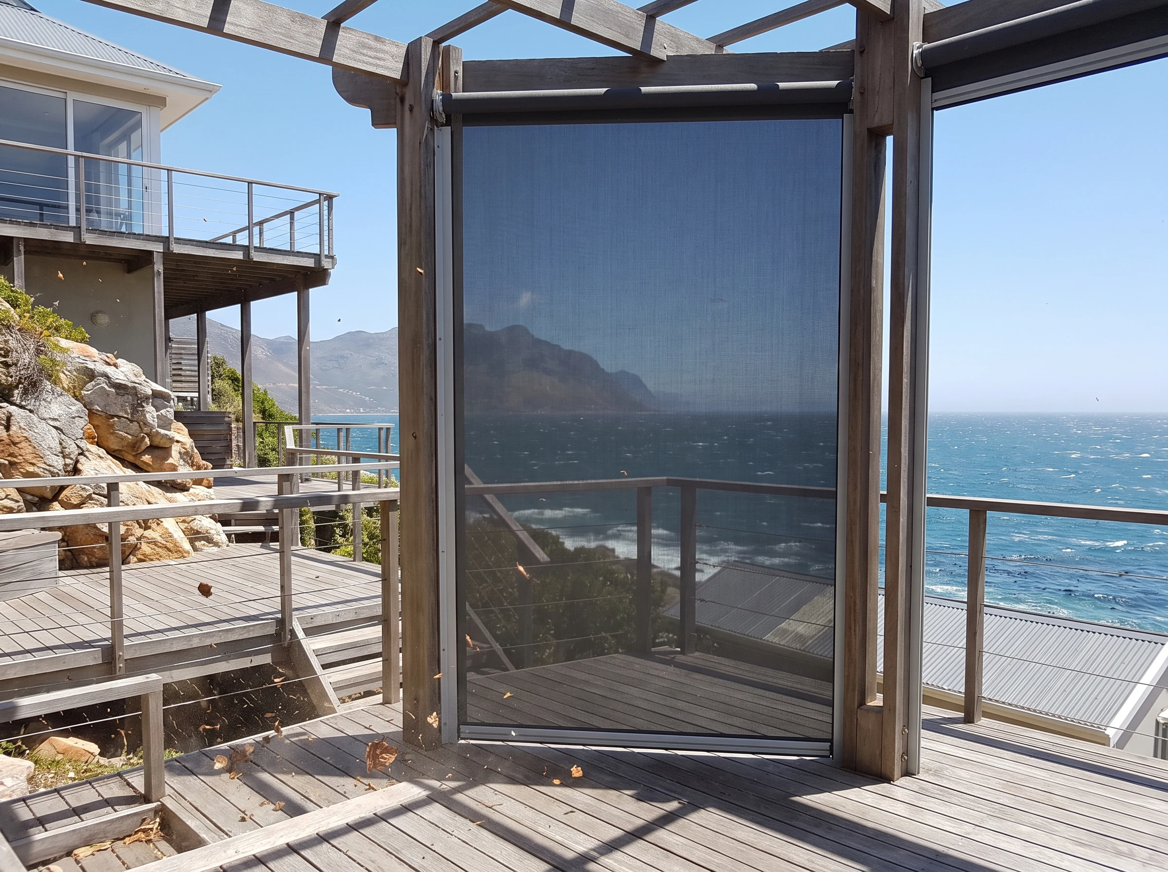 Zip-track outdoor screen enclosing a timber deck on an exposed St James clifftop position above False Bay